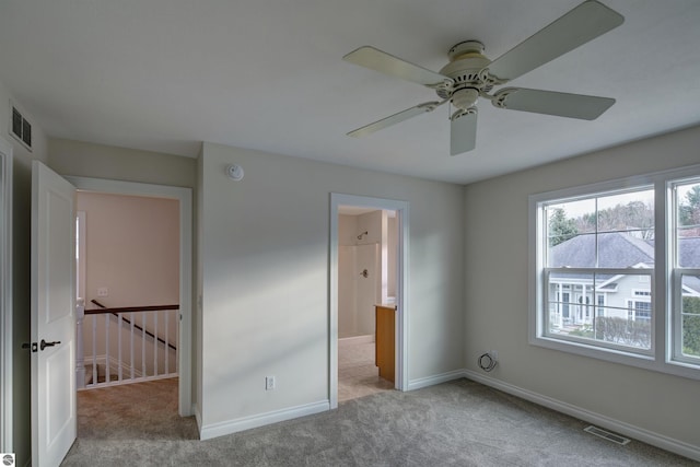 unfurnished bedroom featuring ceiling fan and light carpet