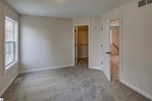 unfurnished room with light carpet