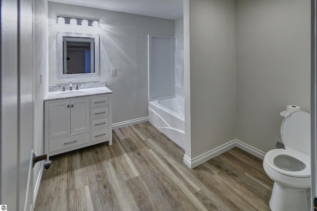 full bathroom featuring hardwood / wood-style flooring, vanity, toilet, and shower / tub combination