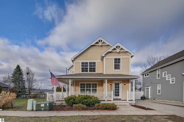 view of front of property with a porch and central air condition unit