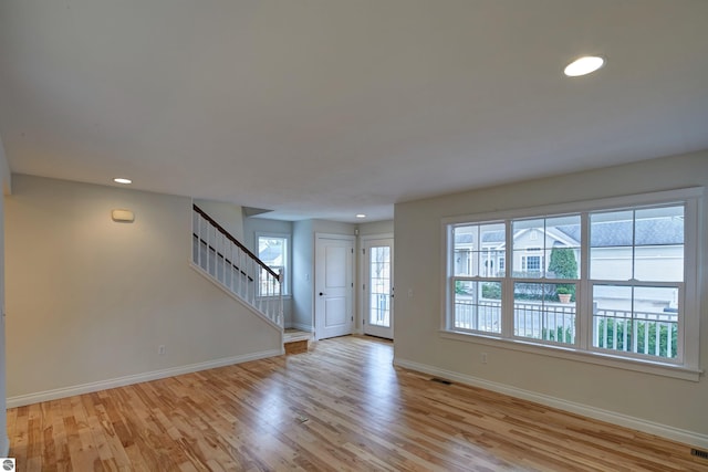 unfurnished living room with light wood-type flooring