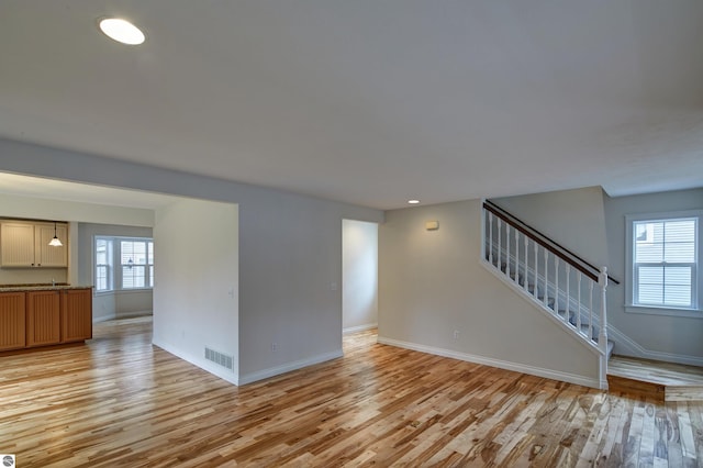 unfurnished living room featuring light wood-type flooring