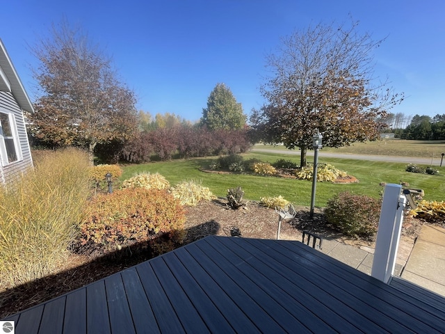 wooden deck with a lawn