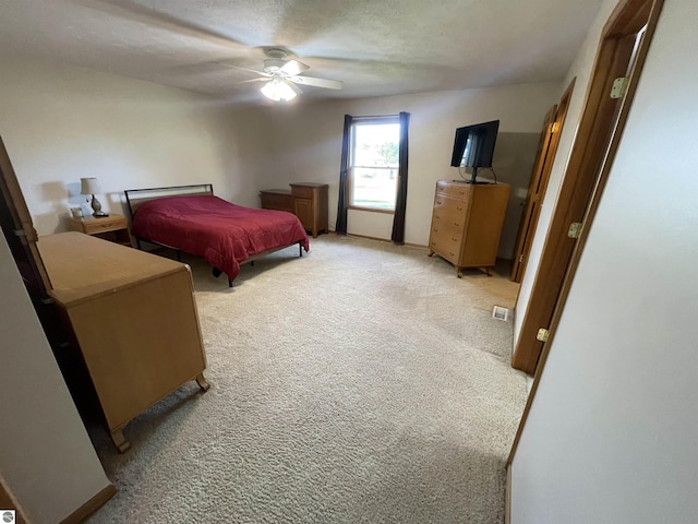 bedroom featuring ceiling fan and light carpet