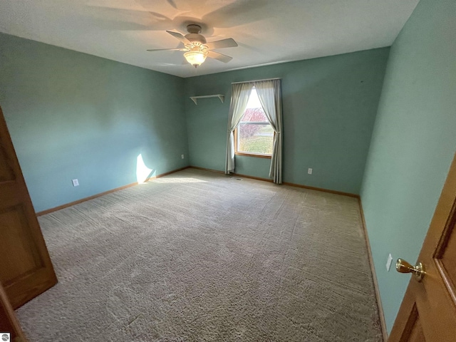 unfurnished room featuring light carpet and ceiling fan