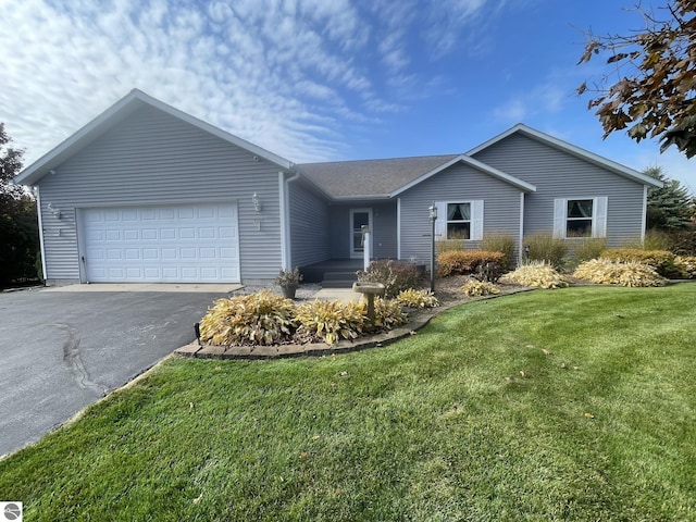 single story home featuring a garage and a front lawn