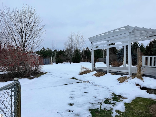 yard layered in snow with a pergola