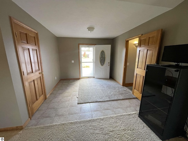 foyer entrance with light carpet