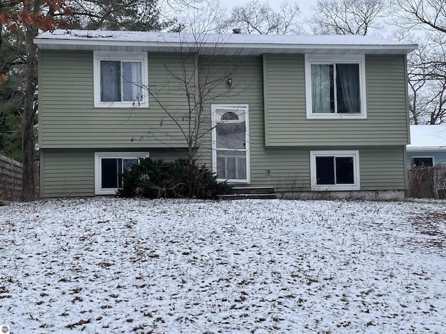 view of snow covered rear of property