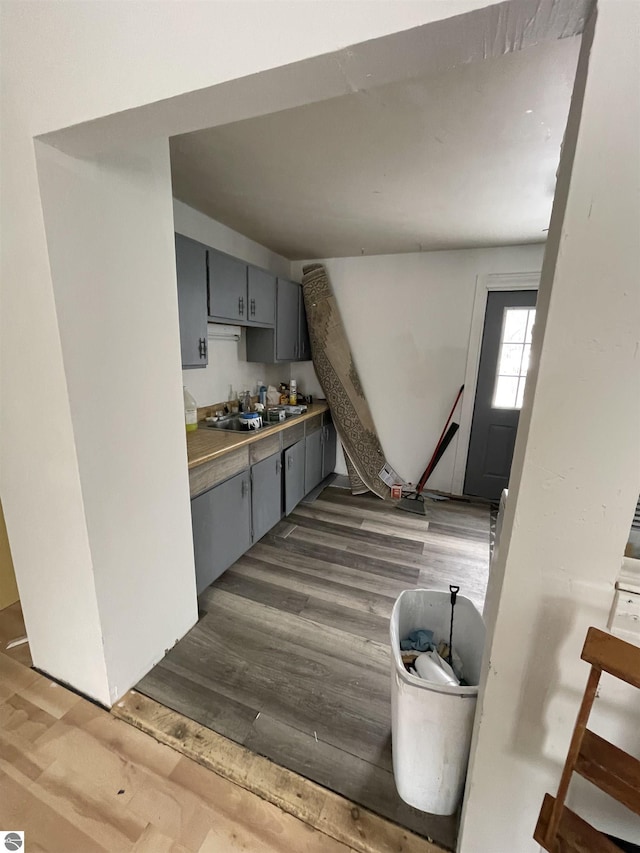 kitchen with gray cabinetry, sink, and dark hardwood / wood-style floors