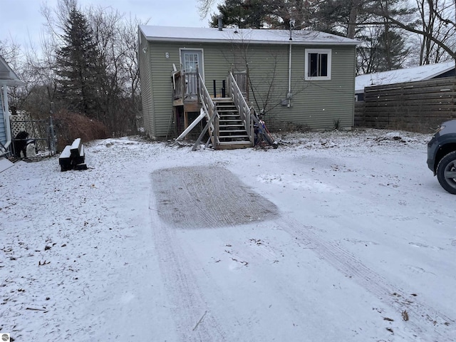 view of snow covered back of property