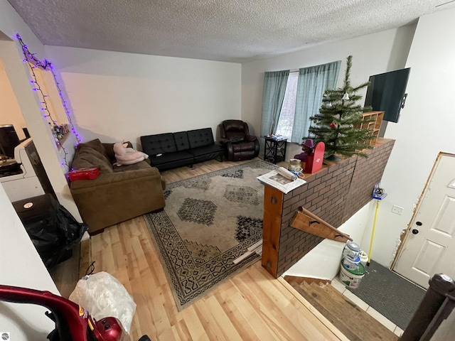 living room with hardwood / wood-style flooring and a textured ceiling