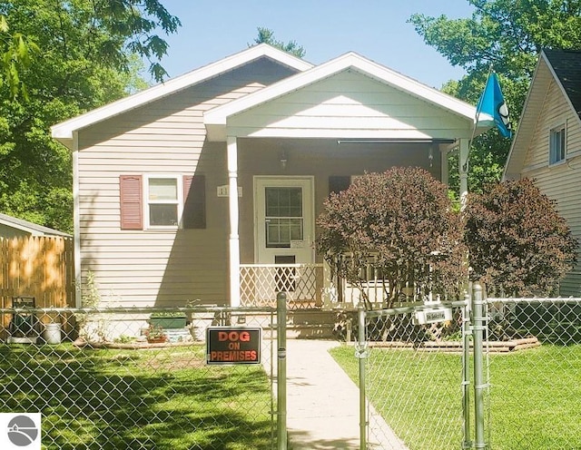 bungalow with a front lawn and covered porch