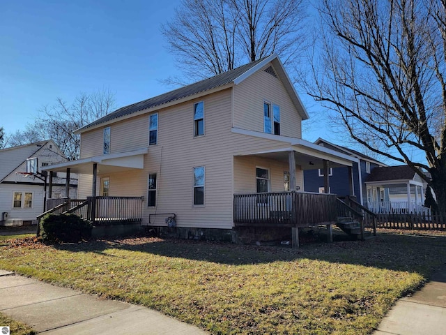 view of front facade featuring covered porch and a front yard