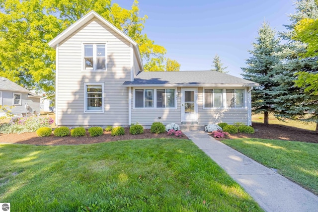 view of front of property with a front lawn and a sunroom