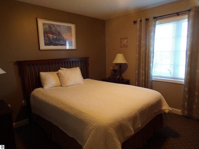 carpeted bedroom featuring multiple windows