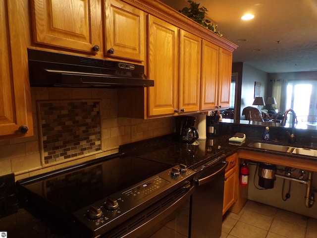 kitchen featuring sink, black dishwasher, tasteful backsplash, light tile patterned flooring, and range