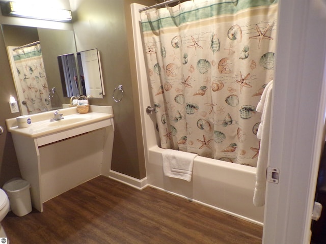 bathroom featuring vanity, hardwood / wood-style floors, and shower / bathtub combination with curtain