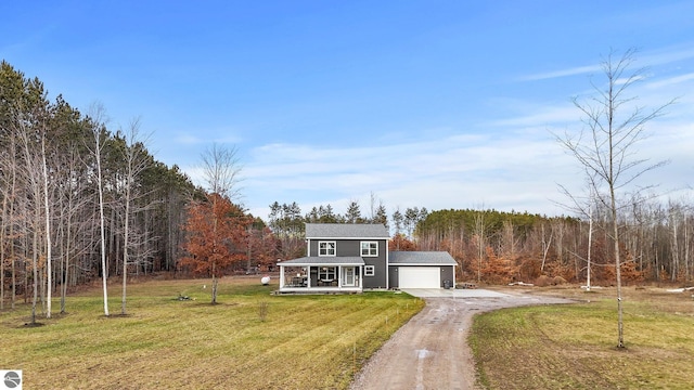 view of front of house with covered porch, a garage, and a front lawn