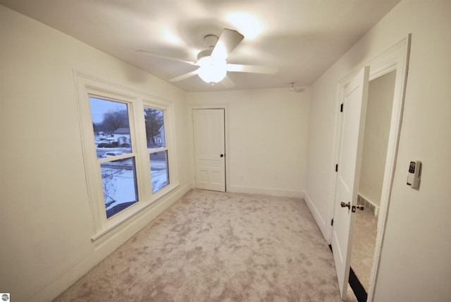 carpeted empty room with ceiling fan