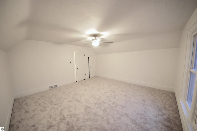 additional living space featuring carpet, ceiling fan, and lofted ceiling