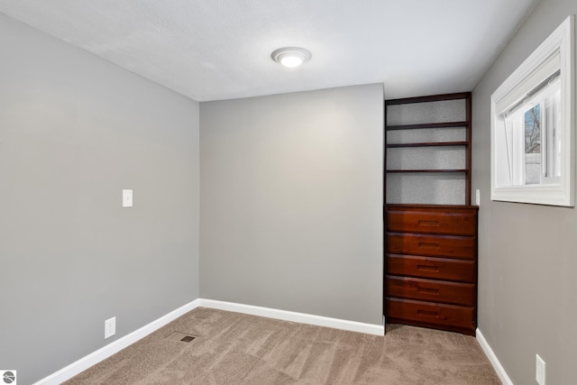 unfurnished bedroom featuring light carpet