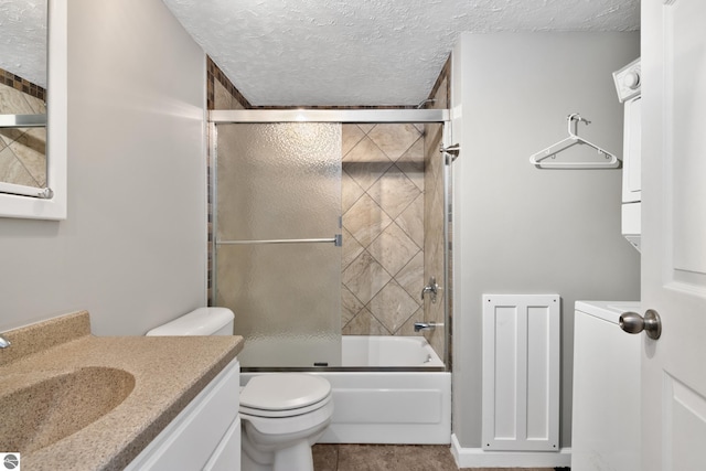 full bathroom with vanity, a textured ceiling, toilet, and enclosed tub / shower combo