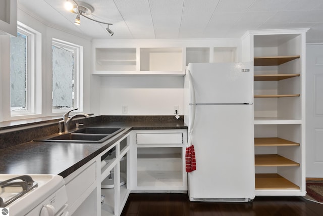 kitchen with white cabinets, sink, white fridge, and a healthy amount of sunlight