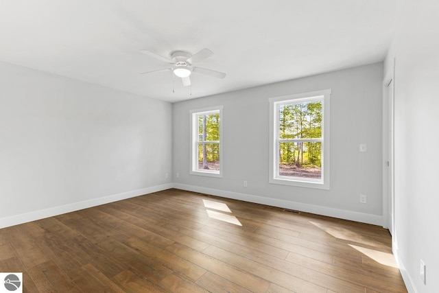 unfurnished room with ceiling fan and wood-type flooring