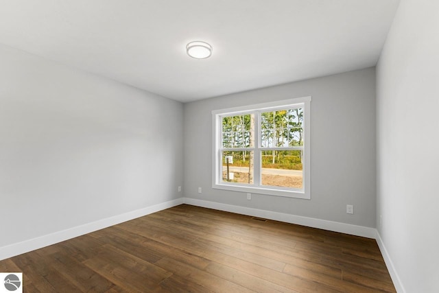 spare room with hardwood / wood-style floors