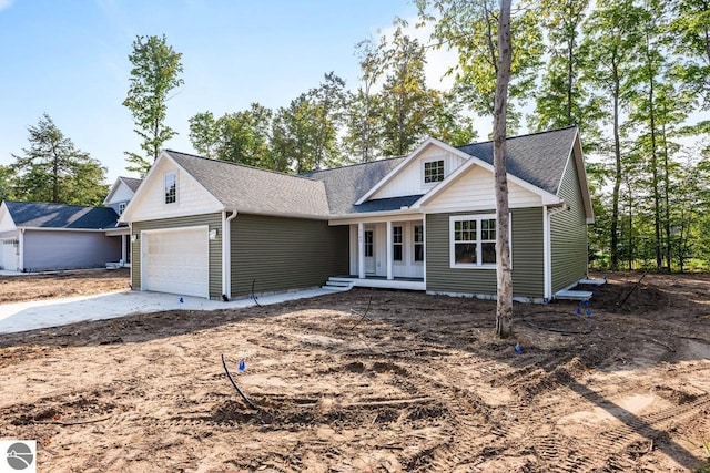 view of front of home with covered porch and a garage