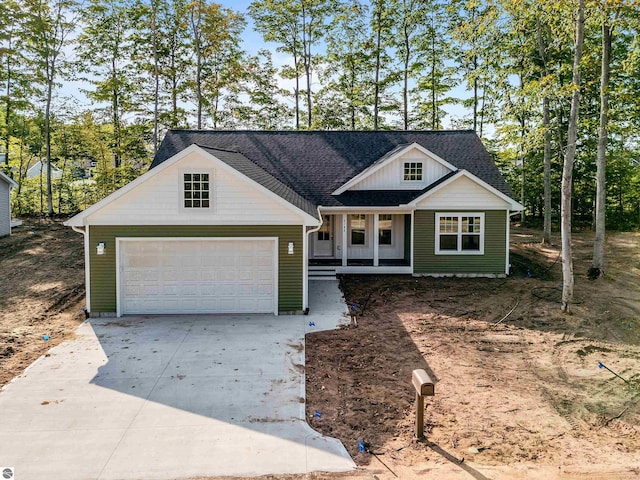 view of front of property featuring covered porch and a garage