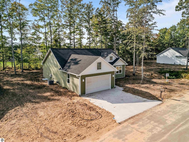 view of front of house featuring central AC and a garage