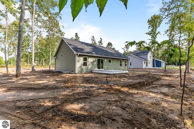 rear view of house featuring a wooden deck