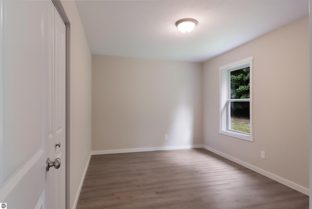 unfurnished room featuring dark hardwood / wood-style floors