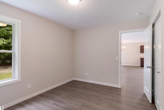 empty room with dark hardwood / wood-style flooring