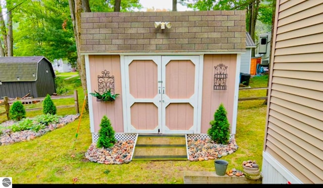 view of outbuilding with a lawn