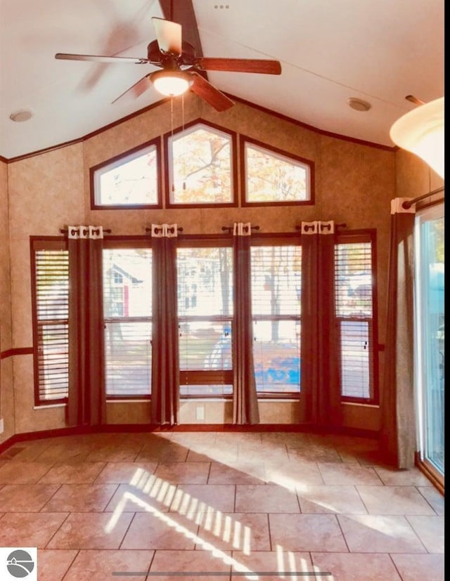 doorway with high vaulted ceiling, ceiling fan, and a healthy amount of sunlight