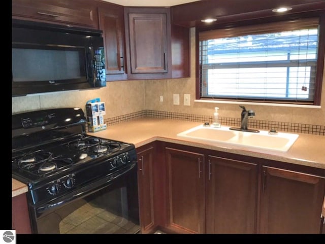 kitchen with black appliances, sink, and a wealth of natural light