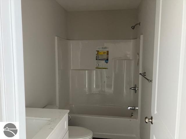 full bathroom featuring shower / washtub combination, vanity, and toilet