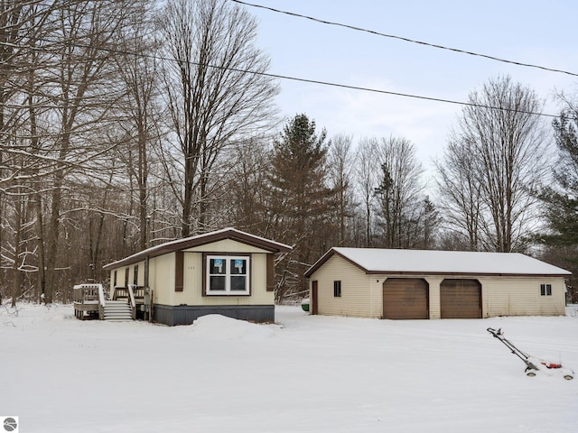 exterior space with a garage and an outdoor structure