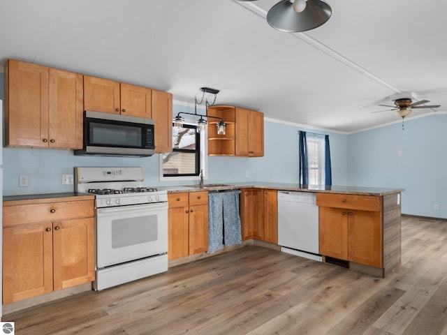 kitchen with white appliances, sink, ceiling fan, light hardwood / wood-style floors, and kitchen peninsula