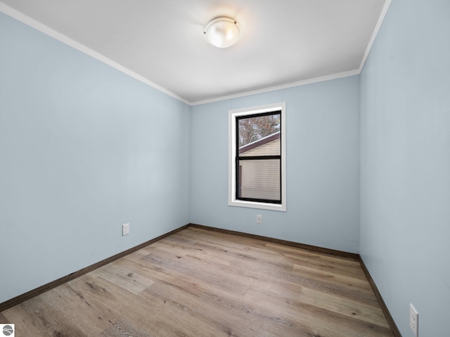 empty room with light hardwood / wood-style floors and crown molding