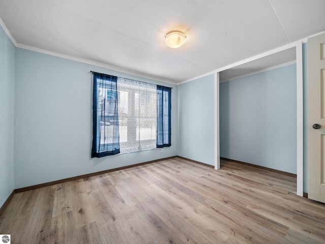 unfurnished bedroom with light hardwood / wood-style floors and crown molding