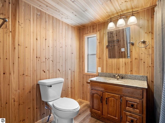 bathroom featuring vanity, wood walls, wood-type flooring, toilet, and wood ceiling