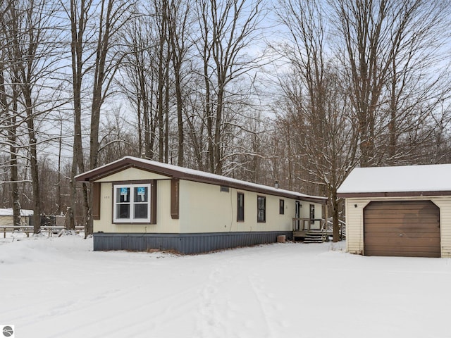 view of front of house featuring a garage, an outdoor structure, and a deck