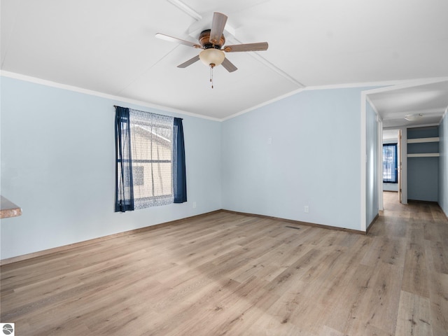 spare room with lofted ceiling, light hardwood / wood-style floors, ceiling fan, and crown molding