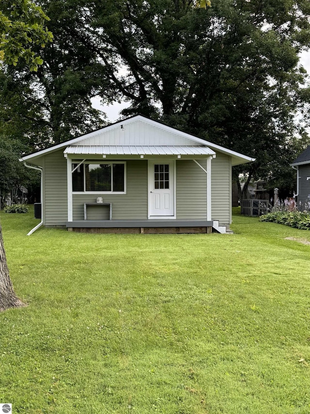 rear view of house with a lawn