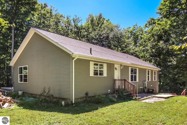 rear view of house with a yard