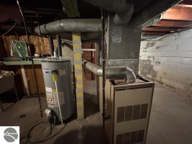 utility room featuring gas water heater